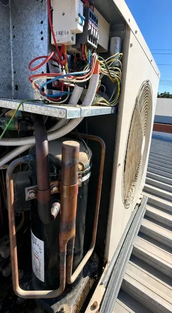 Rooftop air conditioning condenser opened up for repair in Echuca