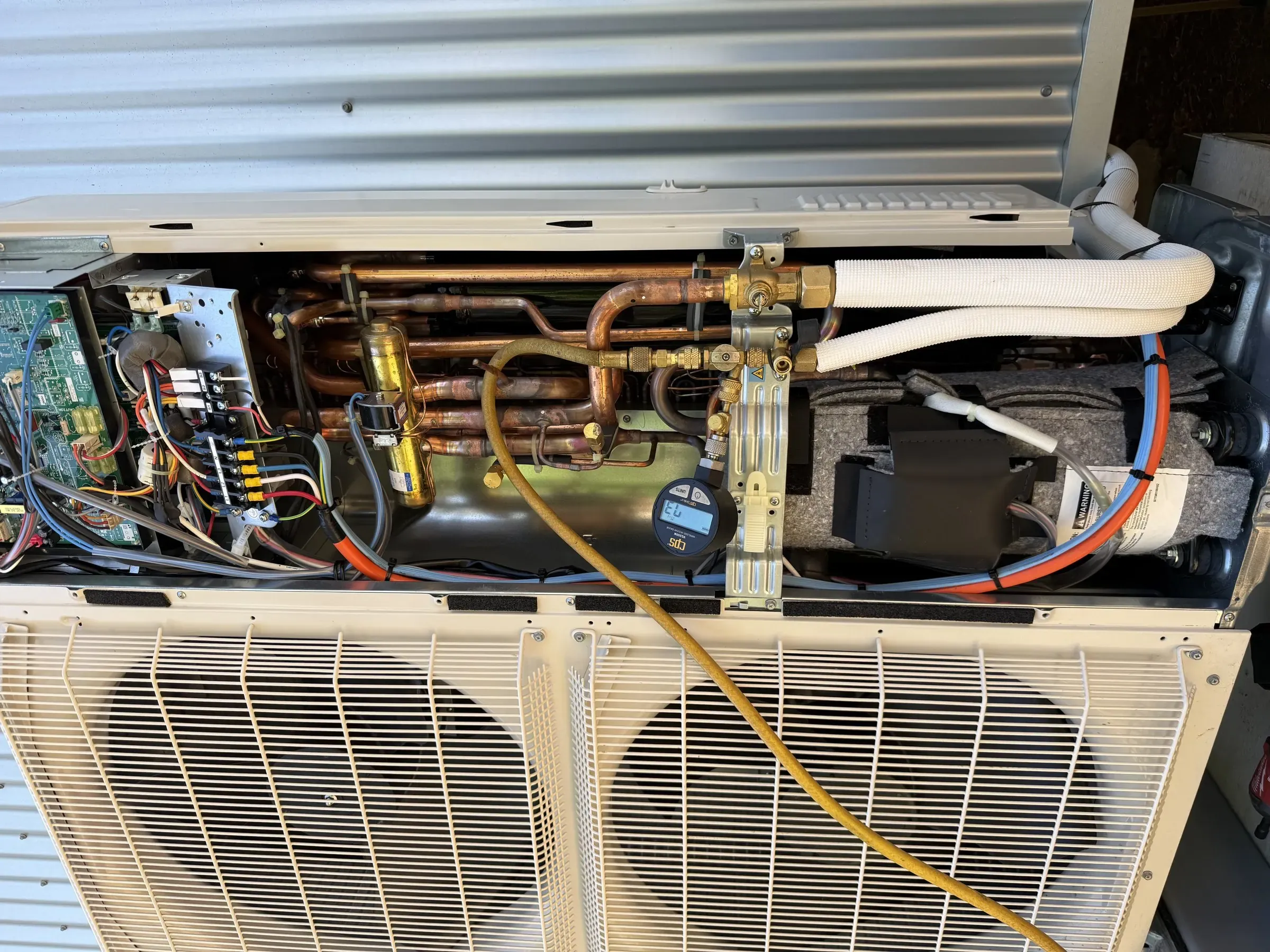 Ireland Refrigeration technician servicing the internal pipework of an air conditioning unit