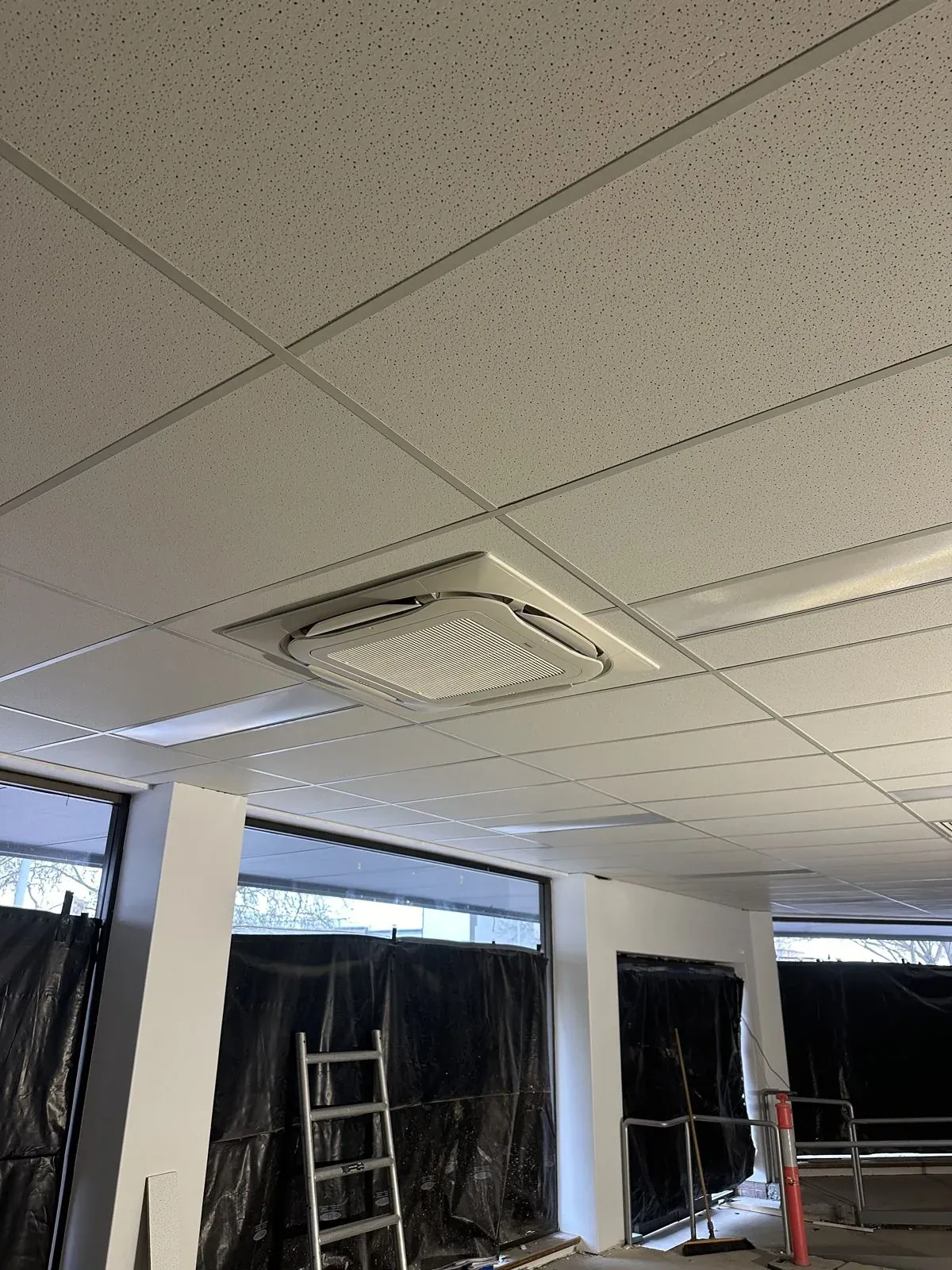 Ceiling cassette air conditioner installed in a commercial fit-out under construction