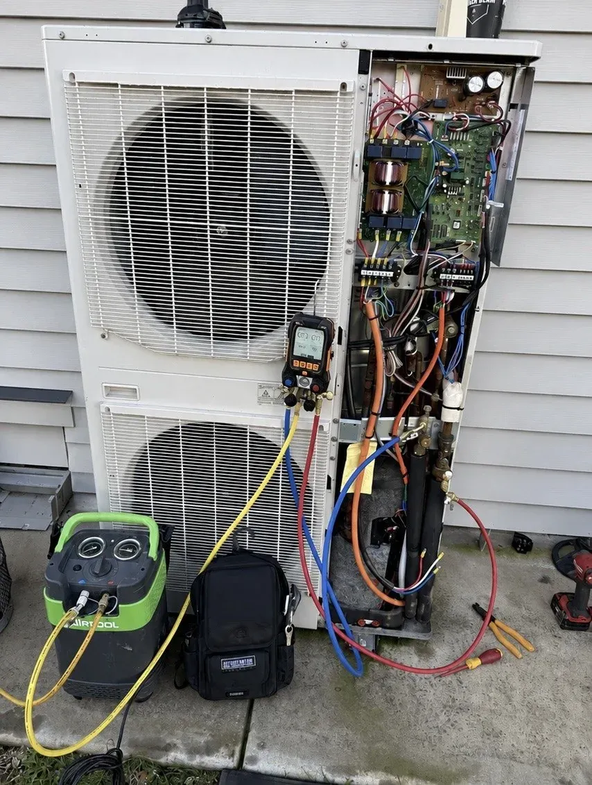 Refrigerant gauges connected to a twin fan outdoor unit during fault finding